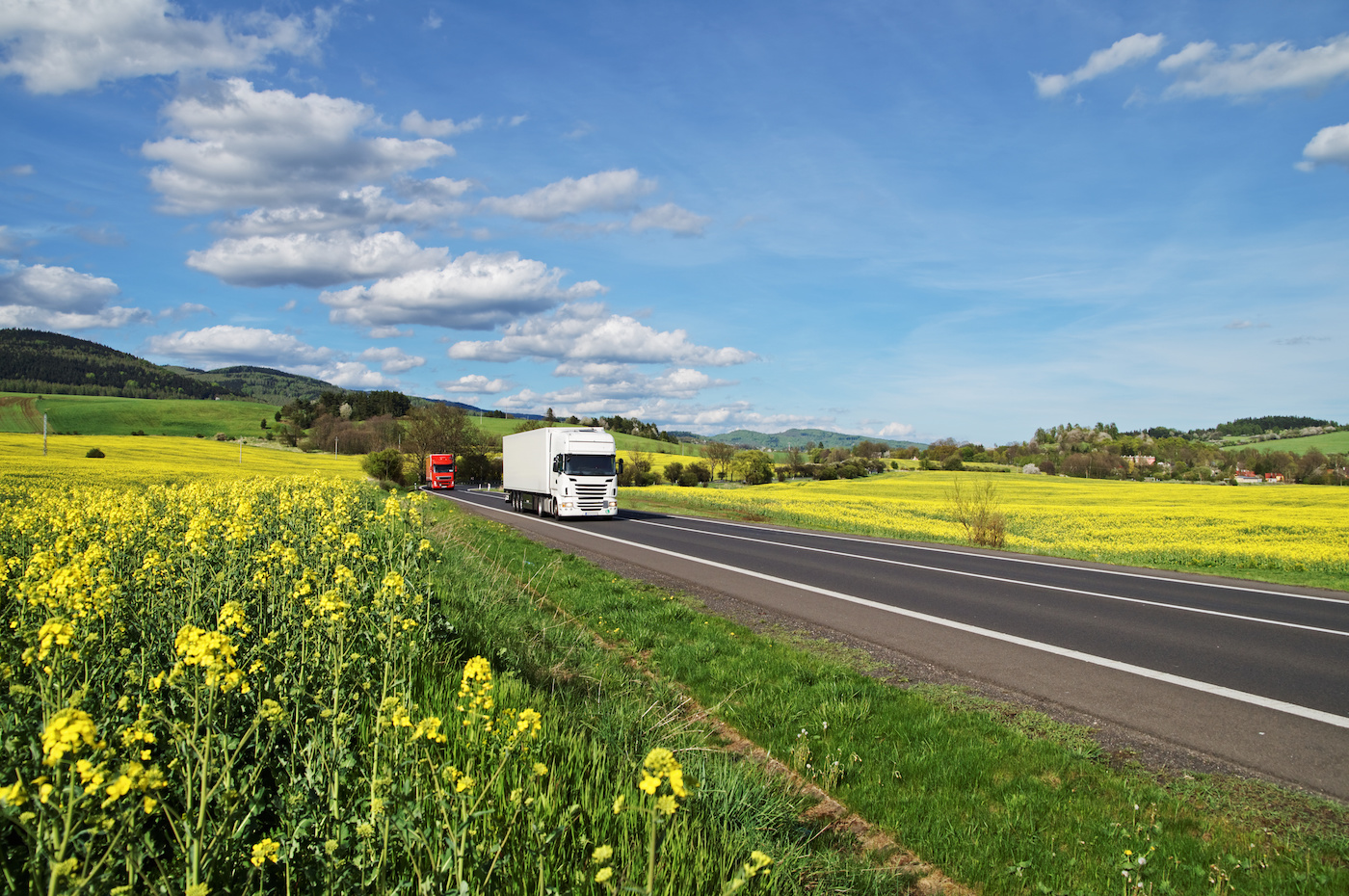 truck-driving-past-field